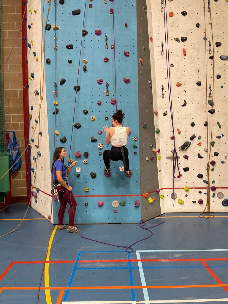 tor and client at the climbing wall